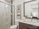 Modern bathroom featuring a glass shower, neutral tile, framed mirror, and vanity with clean lines at 116 Hunt Camp Trl # 11, Davidson, NC 28036