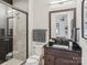 Modern bathroom featuring tiled shower, dark wood vanity, and neutral color palette at 116 Hunt Camp Trl # 11, Davidson, NC 28036