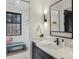 Modern bathroom featuring a sleek vanity and an attached walk-in closet with a window view at 116 Hunt Camp Trl # 11, Davidson, NC 28036