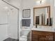 Modern bathroom with a glass shower, wooden vanity, and neutral color palette at 116 Hunt Camp Trl # 11, Davidson, NC 28036