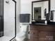 Modern bathroom with stylish dark wood vanity and walk-in shower at 116 Hunt Camp Trl # 11, Davidson, NC 28036