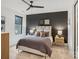 Stylish bedroom featuring a black accent wall, neutral decor, and a ceiling fan at 116 Hunt Camp Trl # 11, Davidson, NC 28036