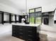 Spacious walk-in closet with black cabinetry, white countertops, and a window offering natural light at 116 Hunt Camp Trl # 11, Davidson, NC 28036