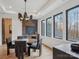 Dining area features a dark wood table, contemporary chandelier, and large windows at 116 Hunt Camp Trl # 11, Davidson, NC 28036