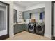 Functional laundry room with cabinetry, countertop space, and modern washer and dryer units at 116 Hunt Camp Trl # 11, Davidson, NC 28036