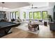Bright and airy living room with large windows, a pool table, and comfortable seating at 116 Hunt Camp Trl # 11, Davidson, NC 28036