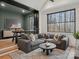 Comfortable living room with a large gray sectional couch, natural light, and a view into the office at 116 Hunt Camp Trl # 11, Davidson, NC 28036