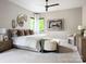 Spacious bedroom featuring a king bed, accent wall decor, and an abundance of natural light at 116 Hunt Camp Trl # 11, Davidson, NC 28036