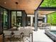 Open-air outdoor kitchen with premium appliances and barstool seating offers a perfect entertainment space at 116 Hunt Camp Trl # 11, Davidson, NC 28036