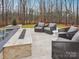 Stylish outdoor seating area with comfortable chairs, a fire feature, and a serene backyard view at 116 Hunt Camp Trl # 11, Davidson, NC 28036