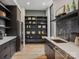 Well-organized pantry featuring custom shelving, black backsplash, and stainless steel appliances at 116 Hunt Camp Trl # 11, Davidson, NC 28036