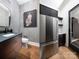 Modern powder room featuring unique wallpaper, a dark vanity, and stylish accents paired with a stainless refrigerator at 116 Hunt Camp Trl # 11, Davidson, NC 28036