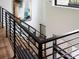 Modern staircase with sleek metal railings and light wood floors offers a stylish transition between levels at 116 Hunt Camp Trl # 11, Davidson, NC 28036