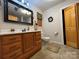 Bathroom features a wood vanity with drawers and a decorative mirror at 369 Pinecrest Cir, Troy, NC 27371