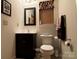 Compact bathroom with dark vanity and medicine cabinet at 369 Pinecrest Cir, Troy, NC 27371