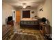 Cozy bedroom features a ceiling fan, warm lighting, and wood-look floors at 369 Pinecrest Cir, Troy, NC 27371