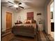 Bedroom with wood floors, a decorative bed, and side table at 369 Pinecrest Cir, Troy, NC 27371