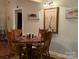 Charming dining area featuring a wood table set, custom fish paintings and a Lake Tillery, NC map at 369 Pinecrest Cir, Troy, NC 27371