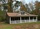 Charming single-story home features a wide porch and green shutters at 369 Pinecrest Cir, Troy, NC 27371