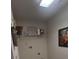 Laundry room with a shelf for storage and a front-loading washing machine hook-up, next to an open door at 369 Pinecrest Cir, Troy, NC 27371