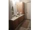 Double sink bathroom with wood cabinets at 5084 Beaver Dam Way, Bessemer City, NC 28016