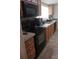 Modern kitchen with black appliances and wood cabinets at 5084 Beaver Dam Way, Bessemer City, NC 28016