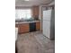 Functional kitchen with white refrigerator and wood cabinets at 5084 Beaver Dam Way, Bessemer City, NC 28016