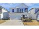 Two-story home with gray and white siding, stone accents, and a two-car garage at 5762 Soft Shell Dr, Lancaster, SC 29720