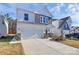 Two-story home with white and blue siding, two-car garage, and landscaping at 5762 Soft Shell Dr, Lancaster, SC 29720