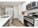 Modern kitchen with white cabinets, stainless steel appliances, and a quartz countertop at 5762 Soft Shell Dr, Lancaster, SC 29720