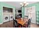 Bright dining area with wood table and chairs, laundry in view at 697 Maple Ridge Cir, Salisbury, NC 28147