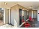 Side view of the porch with black shutters and red chairs at 697 Maple Ridge Cir, Salisbury, NC 28147