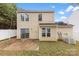 Home's backyard with a concrete patio, small yard space, and white picket fence at 8633 Sawleaf Ct, Charlotte, NC 28215