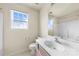 A bathroom features a single sink, neutral walls, and a window for ample natural light at 8633 Sawleaf Ct, Charlotte, NC 28215