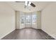 Bright bedroom with natural light, modern flooring, and ceiling fan at 8633 Sawleaf Ct, Charlotte, NC 28215