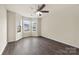 Bedroom featuring large windows, ceiling fan, and modern flooring at 8633 Sawleaf Ct, Charlotte, NC 28215