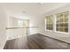 Loft area featuring hardwood floors, natural light, and white railings at 8633 Sawleaf Ct, Charlotte, NC 28215