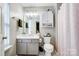 Bathroom with shower/tub combo, vanity, and white toilet at 9149 Washam Potts Rd, Cornelius, NC 28031