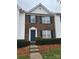 Brick front townhouse with a blue door and neat landscaping at 9149 Washam Potts Rd, Cornelius, NC 28031