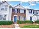 Brick front townhouse with blue shutters and well-manicured landscaping at 9149 Washam Potts Rd, Cornelius, NC 28031