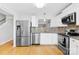 Bright kitchen with stainless steel appliances and granite countertops at 9149 Washam Potts Rd, Cornelius, NC 28031