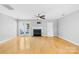 Bright living room featuring hardwood floors and fireplace at 9149 Washam Potts Rd, Cornelius, NC 28031