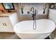 Relaxing bathroom with a modern free-standing bathtub and granite countertops at 98 Poplar Woods Dr, Concord, NC 28027