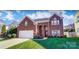 Brick two-story house with a large yard and attached garage at 98 Poplar Woods Dr, Concord, NC 28027