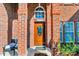 Welcoming front porch with brick columns and a stained glass door at 98 Poplar Woods Dr, Concord, NC 28027