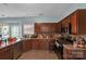 Kitchen with wood cabinets, stainless steel appliances, and tile countertops at 98 Poplar Woods Dr, Concord, NC 28027