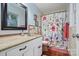 Traditional bathroom featuring a floral shower curtain, ceramic tile floors, and decorative framed prints at 1008 Candlewood Ln, Rock Hill, SC 29730