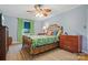 Comfortable bedroom with a rattan bed frame, ceiling fan and natural light from the window at 1008 Candlewood Ln, Rock Hill, SC 29730