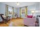 Bright bedroom with hardwood floors, floral curtains, and a cozy rocking chair, creating a warm ambiance at 1008 Candlewood Ln, Rock Hill, SC 29730