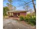 View of a brick carport with fenced in back porch and mature landscaping at 1008 Candlewood Ln, Rock Hill, SC 29730